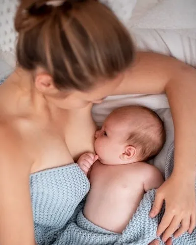 mom feeding baby mothers day photoshoot